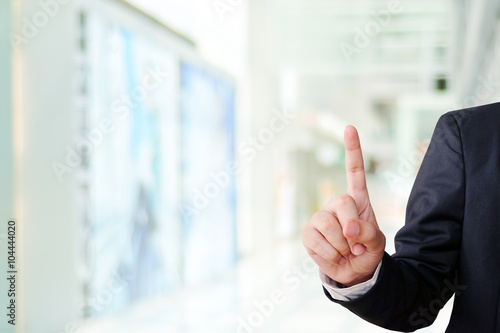 Hand point gesture on blur office background, business concept