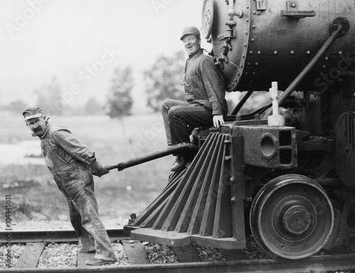 Engineers pulling train engine  photo