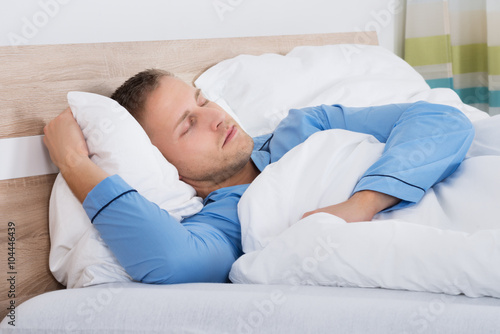 Man Sleeping On Bed
