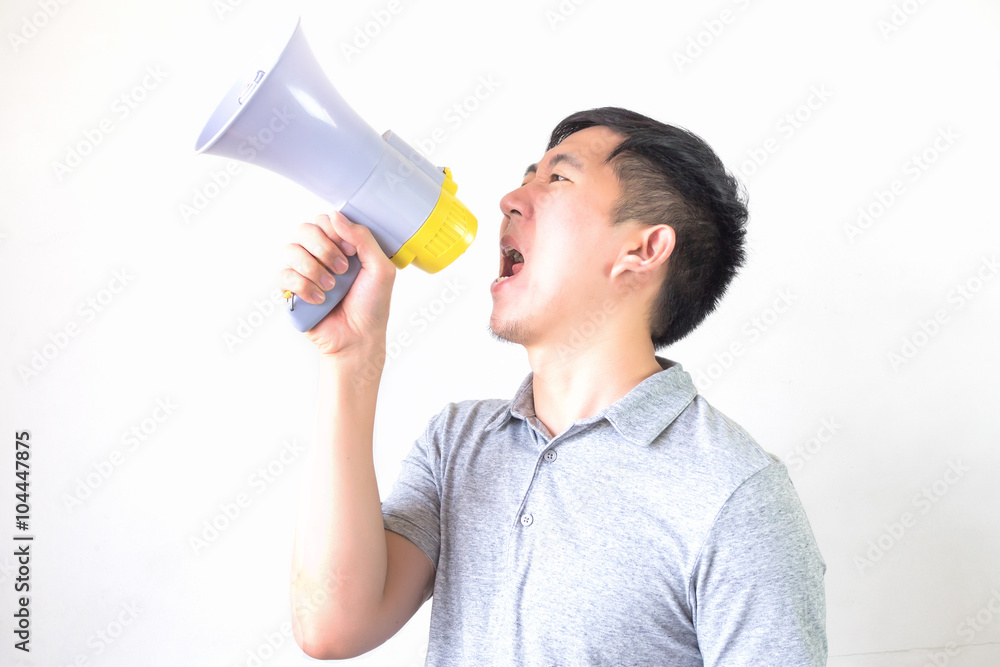 Young Asian man shouting with a megaphone isolated white background Young Asian man shouting with a megaphone isolated white background