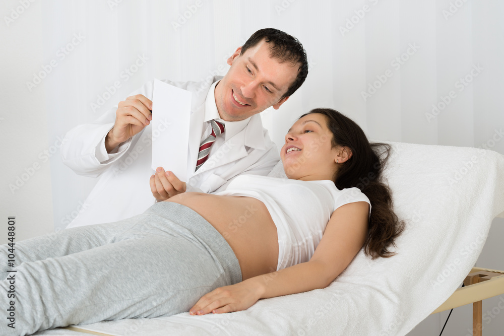 Doctor Showing Ultrasound Scan To Pregnant Woman Doctor Showing Ultrasound Scan To Pregnant Woman