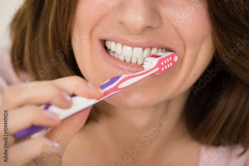 Woman Brushing Teeth With Toothbrush