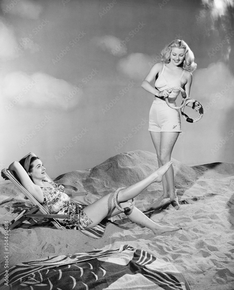 Fototapeta premium Two women relax at the beach 