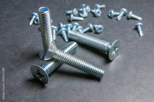 Bolts and Screws on grey. Left upright bolt (right light)