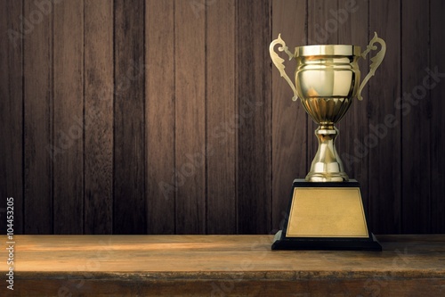 Trophies placed on a wooden floor with a space.