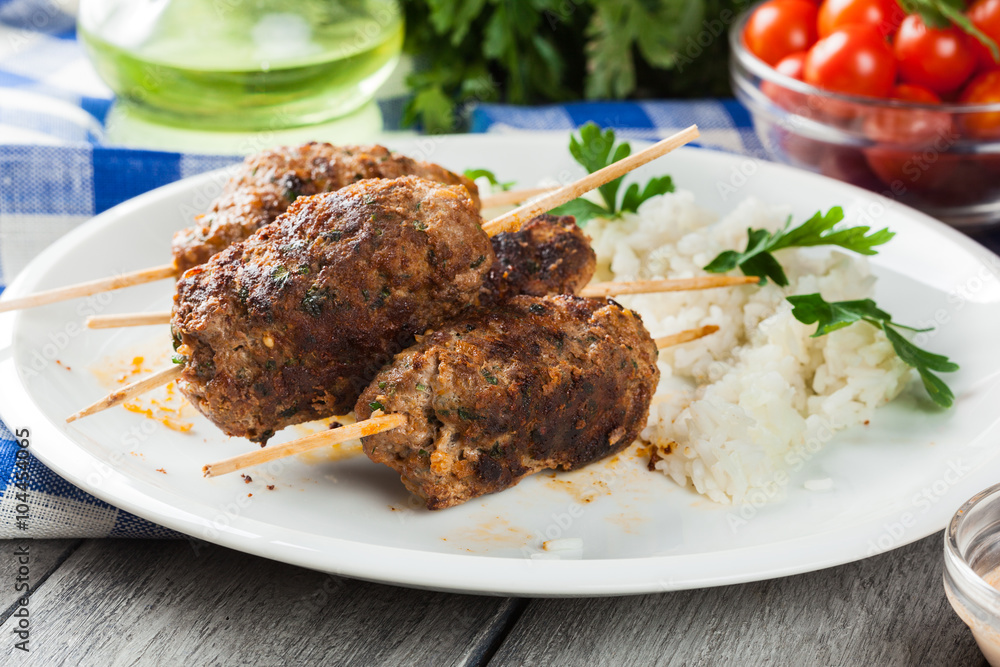 Barbecued kofta with rice on a plate