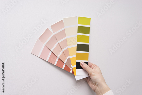 Caucasian female hand holding color samples photo