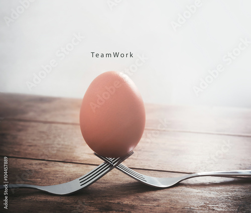 Egg on the fork with text teamwork business concept photo