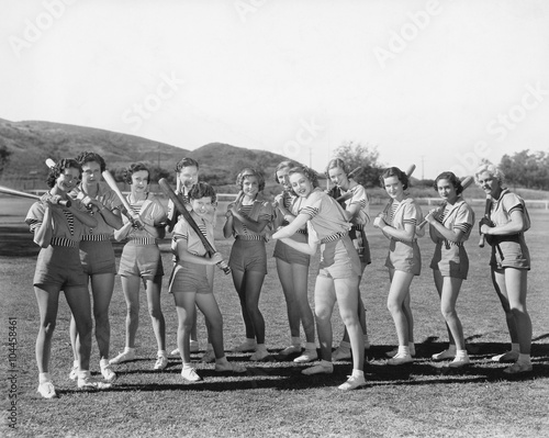 Photography Group of women holding baseball bats and standing in a row