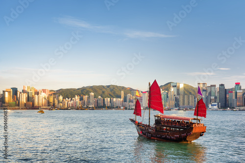 Sailing ship and the Hong Kong Island skyline at evening