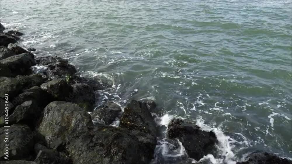 Tight shot of the waves on a rocky shore. Tight shot of the waves on a rocky shore.