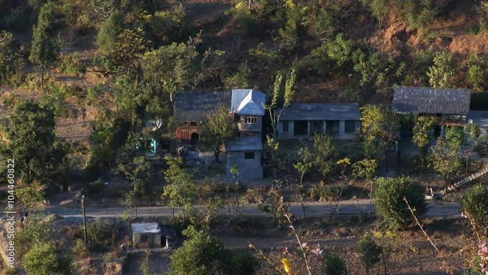 Static shot of several homes in rural Indian area.
