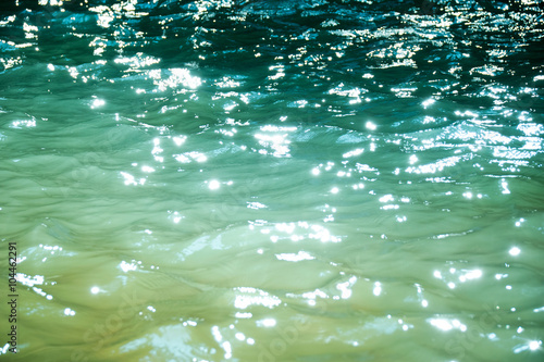 Slika na platnu Emerald green water reflect light abstract background