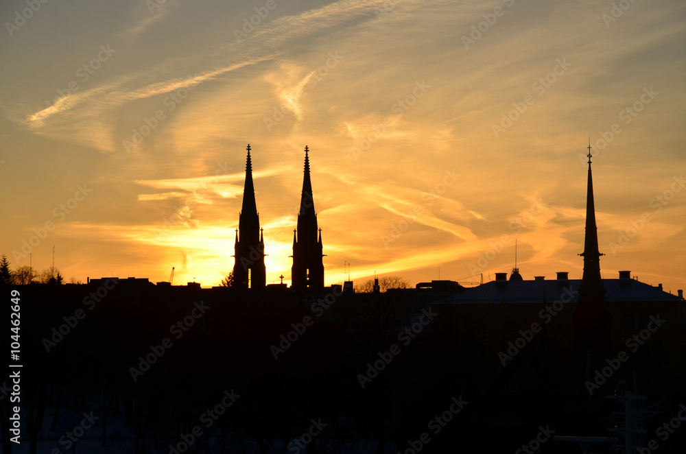 Helsinki silhouette at sunset. Towers of the St. John's Church and the German Church.