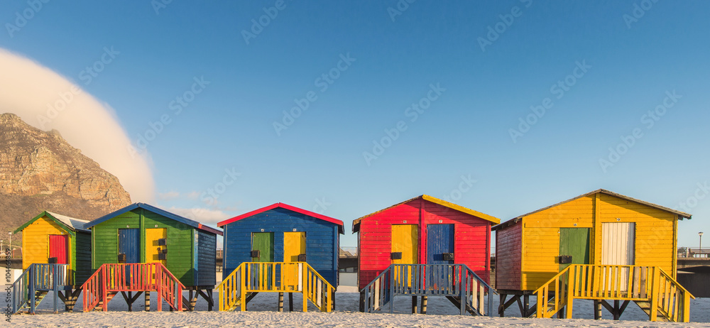 Fototapeta premium Wschód słońca w słynnych kolorowych chatach na plaży Muizenberg poza Kapsztadem