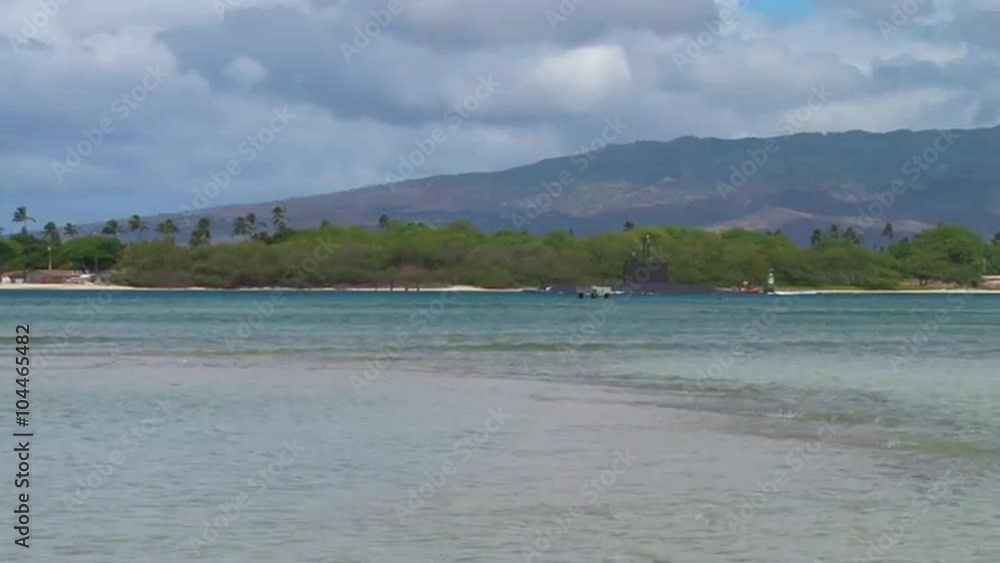 A submarine passes tropical beaches in Hawaii.