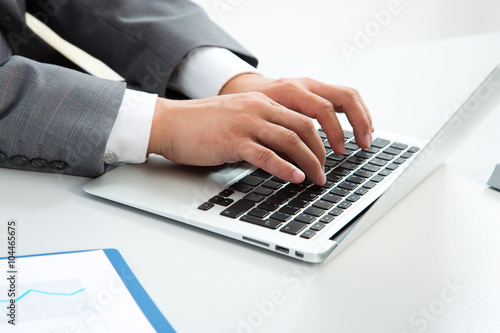 Close-up image of typing male hands