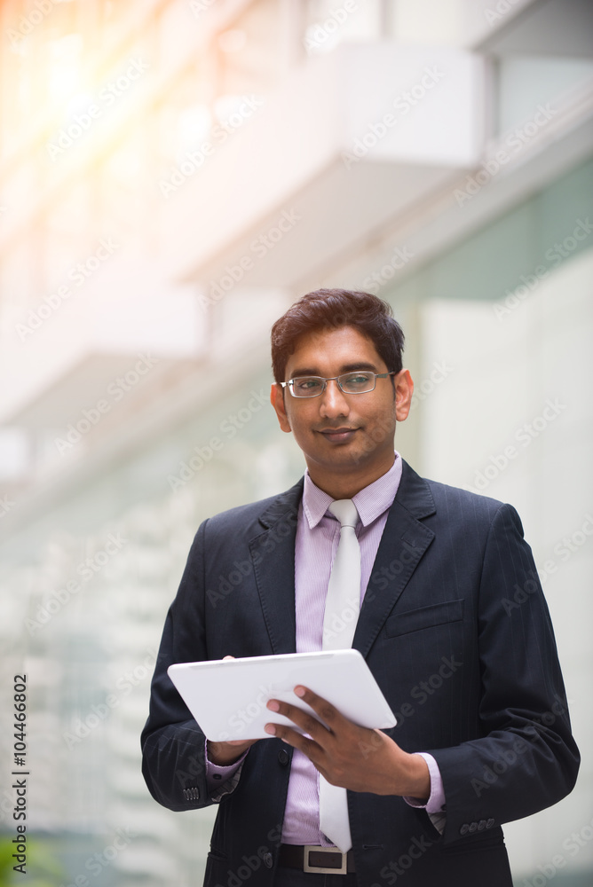 indian male using tablet outdoor indian male using tablet outdoor