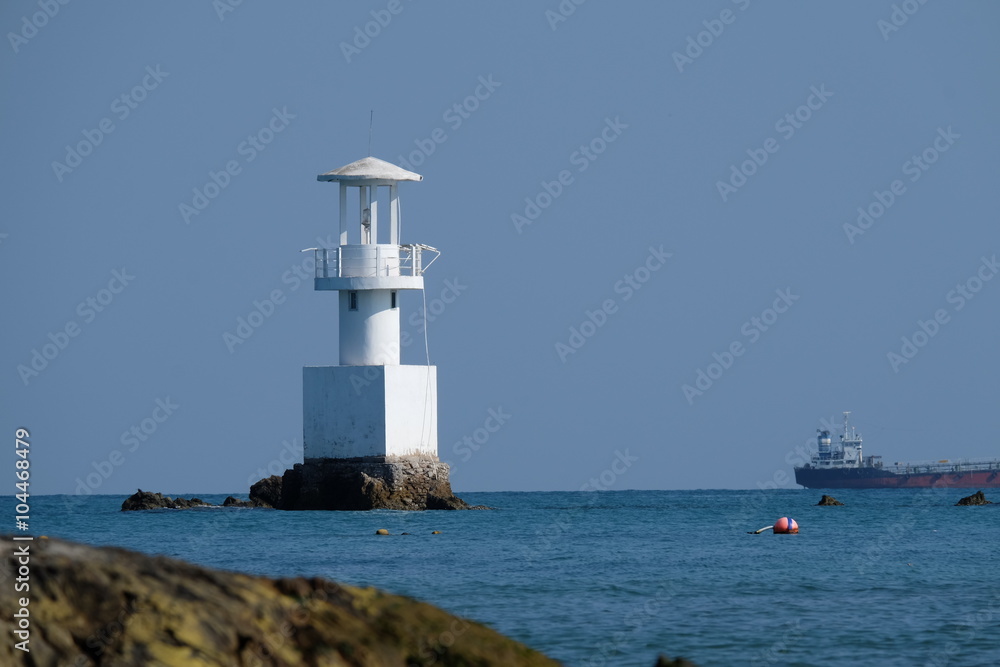 Lighthouse on a sunny day with blue sea.