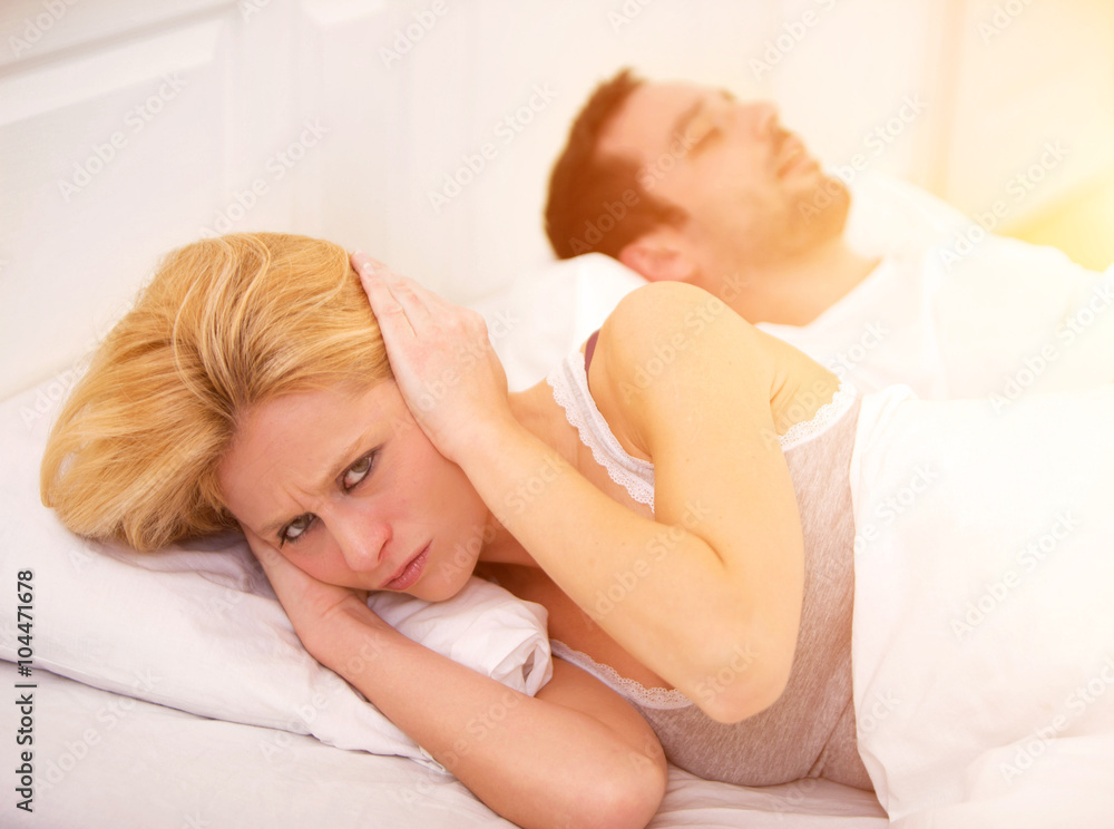 Young woman can't sleep because of boyfriend's snoring Young woman can't sleep because of boyfriend's snoring