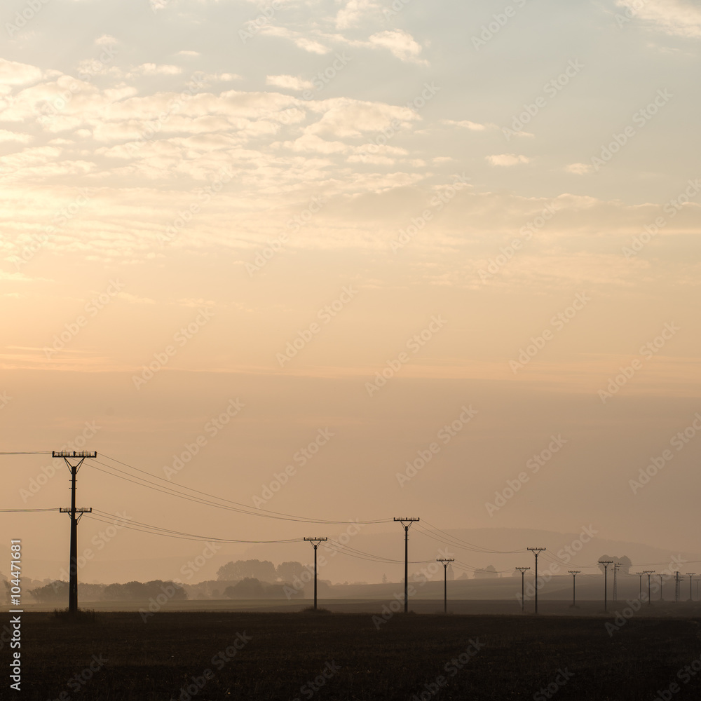 sunset over the fields in fog