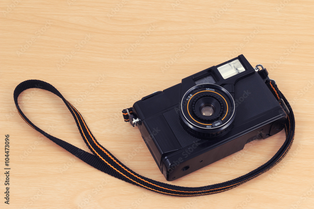 Old camera, vintage camera films popular in the past on wooden desk table.