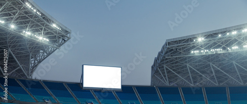 Blue seats and electronic billboard display at stadium