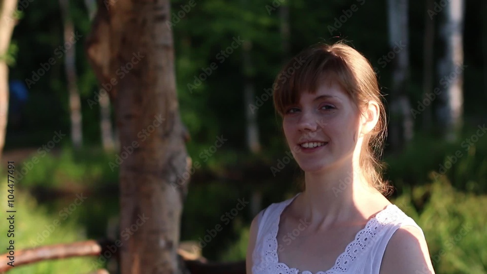 Beautiful smiling woman with bright sunlight on face hides in shade
Beautiful smiling woman with bright sunlight on face hides in shade