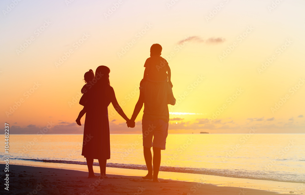 happy family with two kids walking at sunset