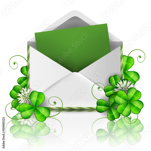 Open envelope with green paper and leaf clover for St. Patrick's Day