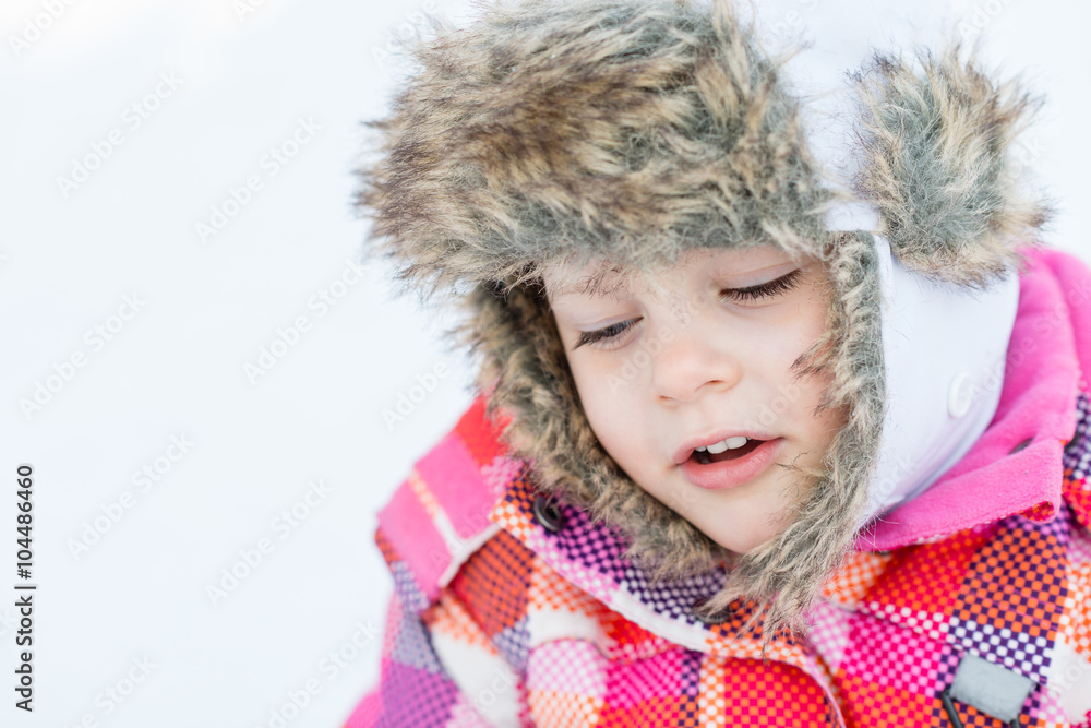 Closeup half-turned portrait of little girl with closed eyes - Happy child girl playing on a winter walk in nature - Winter fun Closeup half-turned portrait of little girl with closed eyes - Happy child girl playing on a winter walk in nature - Winter fun