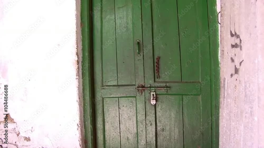 Up close view of green door and latch Up close view of green door and latch