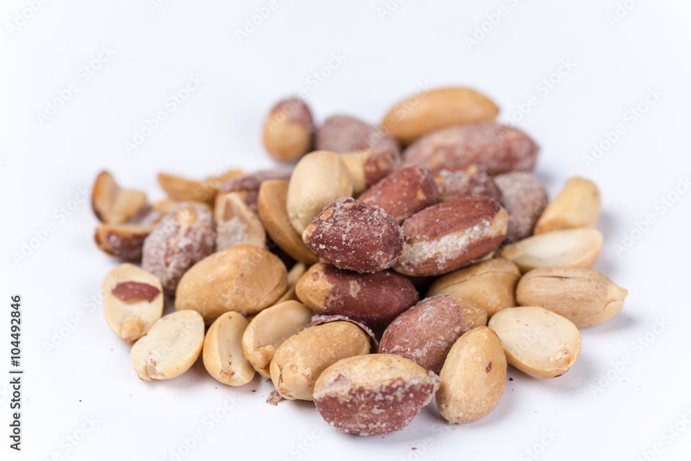 Bunch of roasted peanuts on the white background Bunch of roasted peanuts on the white background