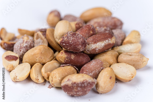 Bunch of roasted peanuts on the white background