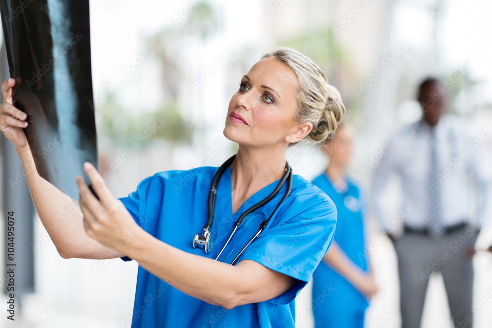 doctor looking at patient's x-ray film doctor looking at patient's x-ray film