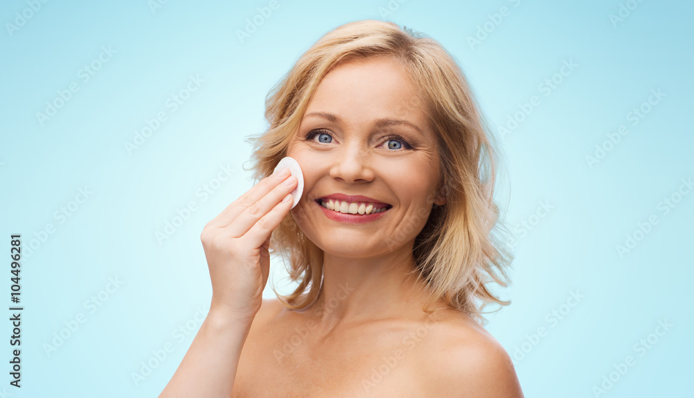 happy woman cleaning face with cotton pad happy woman cleaning face with cotton pad