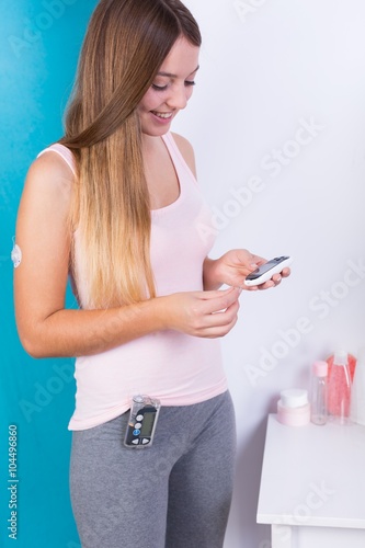 Woman with insulin pump device photo