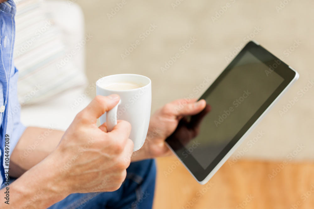close up of man with tablet pc and tea cup at home close up of man with tablet pc and tea cup at home