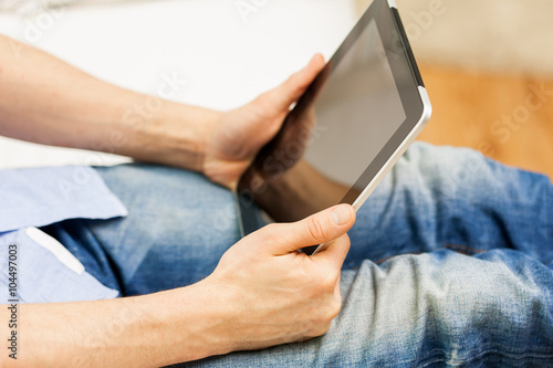 close up of man working with tablet pc at home