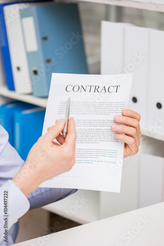 close up of businessman holding contract document