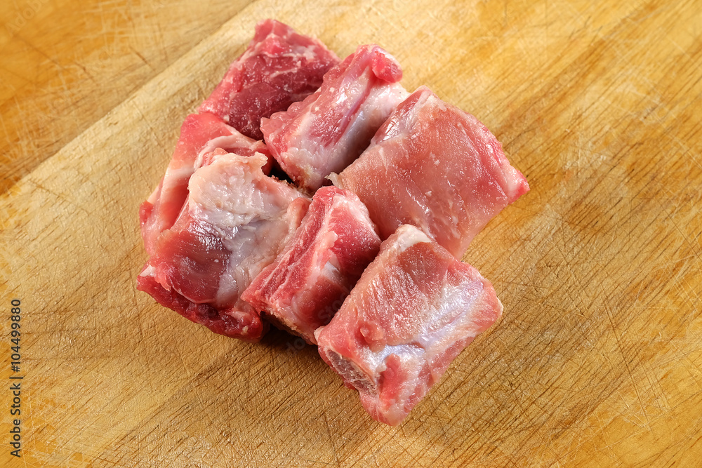 Raw pork ribs on a cutting board - close up