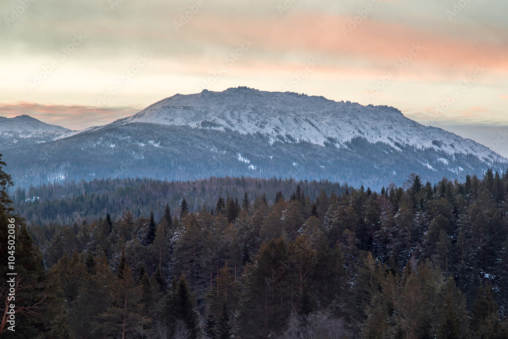 Top of the mountain at sunrise. Ural mountain.Iremel. Majestic landscape glowing by sunlight in the morning. Dramatic and picturesque wintry scene.Beauty world. Happy New Year!