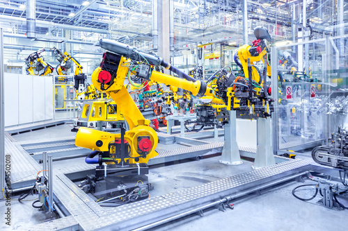 robotic arms in a car plant photo