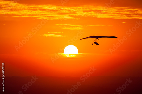 Hang gliding in the sunset photo