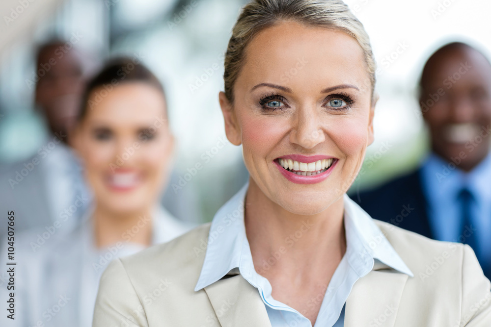 mature businesswoman in front of colleagues mature businesswoman in front of colleagues