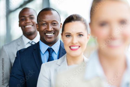 african american businessman standing with colleagues