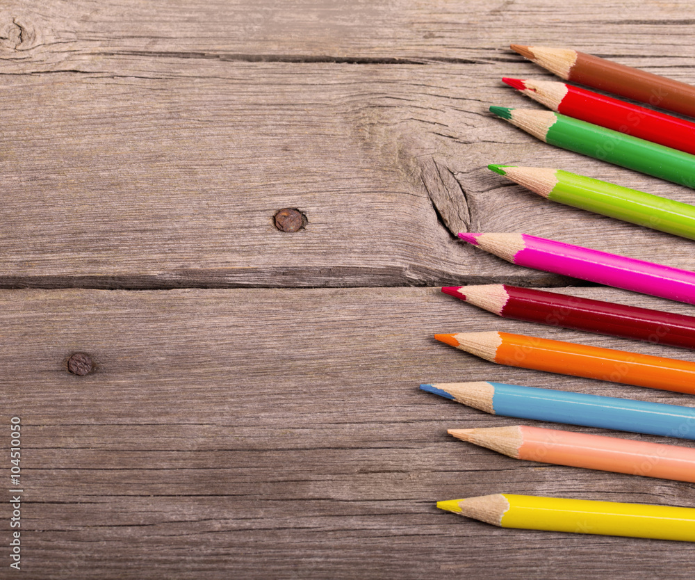 multicolored pencils on the wooden background multicolored pencils on the wooden background