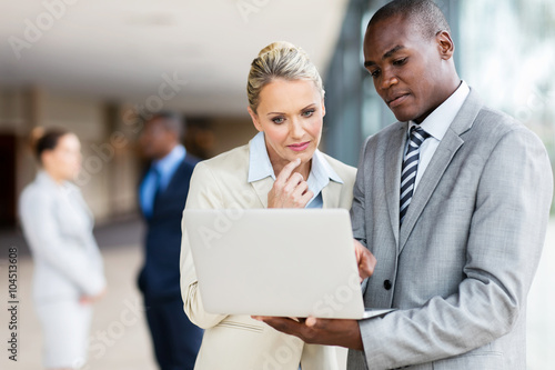 multiracial businesspeople using laptop computer