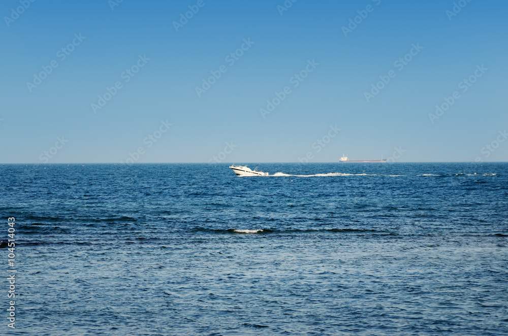 Motor boat in sea on a background of blue sky