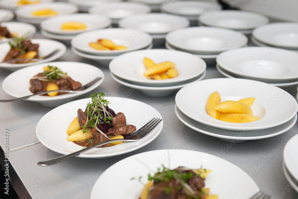 preparation of buffet plates with beef and Schupfnudel dishes - obrazy, fototapety, plakaty 
